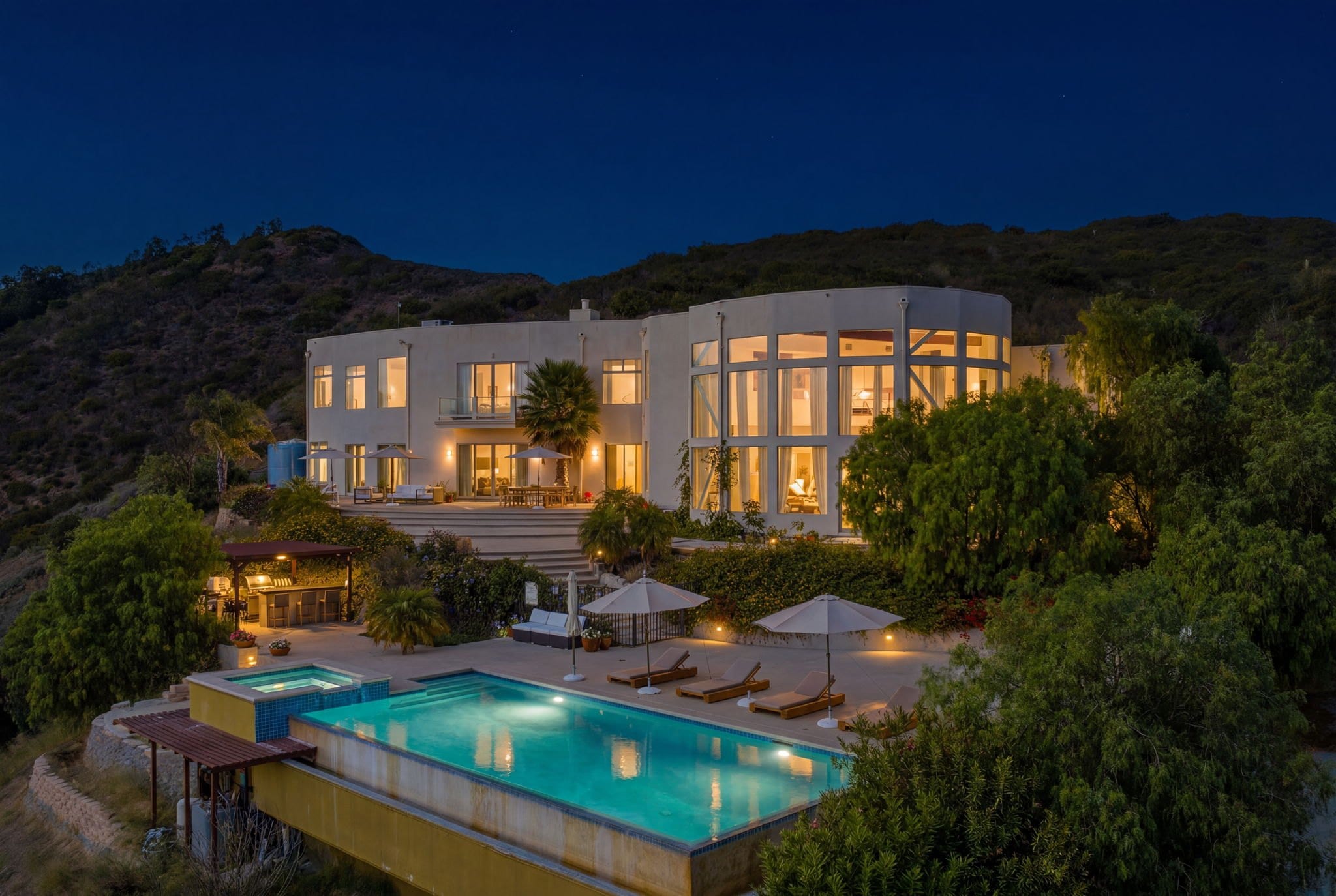 Contemporary Beverly Hills estate at dusk with infinity pool
