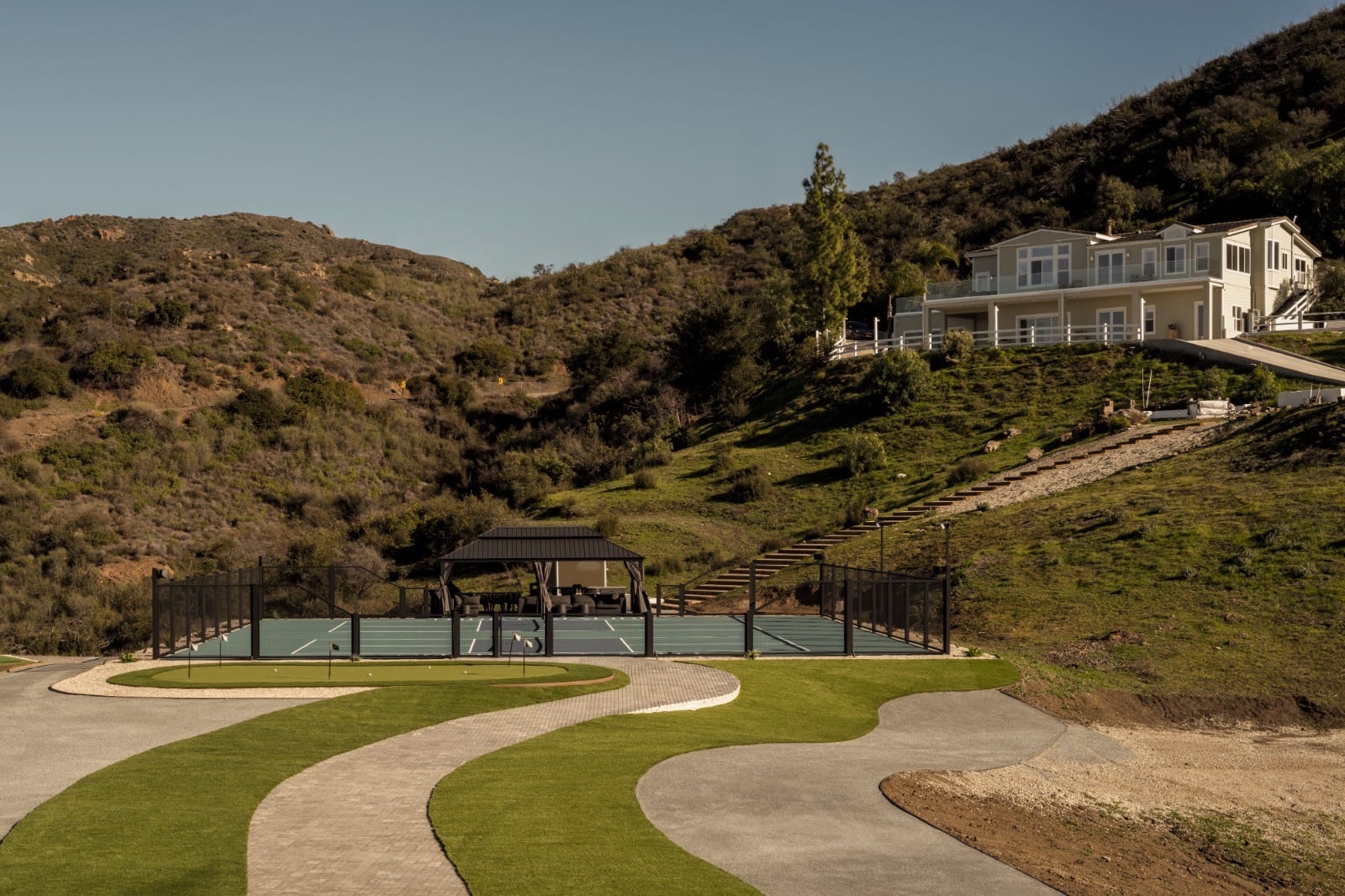 Modern residence approached along a landscaped drive
